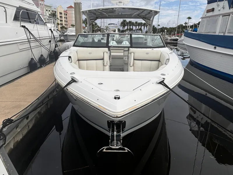 Slide: The Image of 2022 Cobalt 30SC boat docked at marina, surrounded by other vessels. - 8