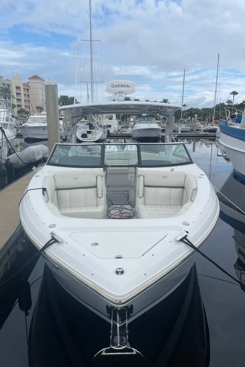 Slide: The Image of 2022 Cobalt 30SC boat docked in marina, front view. - 9