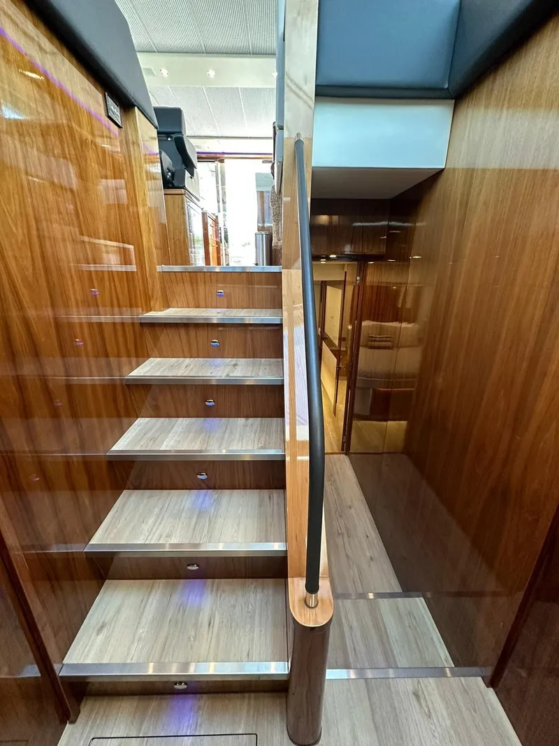 Slide: The Image of Staircase inside 2018 Riviera 60SY yacht with wooden finish and modern design. - 11