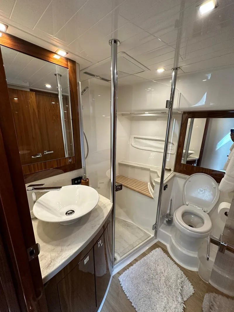 Slide: The Image of Luxurious bathroom in 2018 Riviera 60SY yacht with modern fixtures and elegant design. - 13