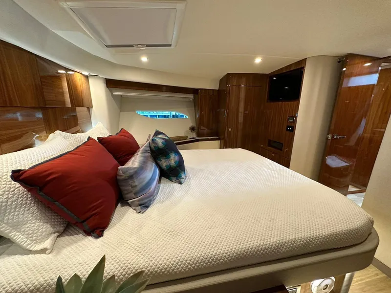 Slide: The Image of Luxurious bedroom interior of 2018 Riviera 60SY yacht with elegant wood finishes. - 14