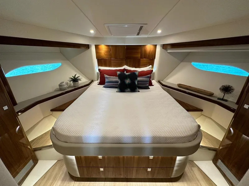 Slide: The Image of Luxurious bedroom interior of 2018 Riviera 60SY yacht with elegant decor and ambient lighting. - 15