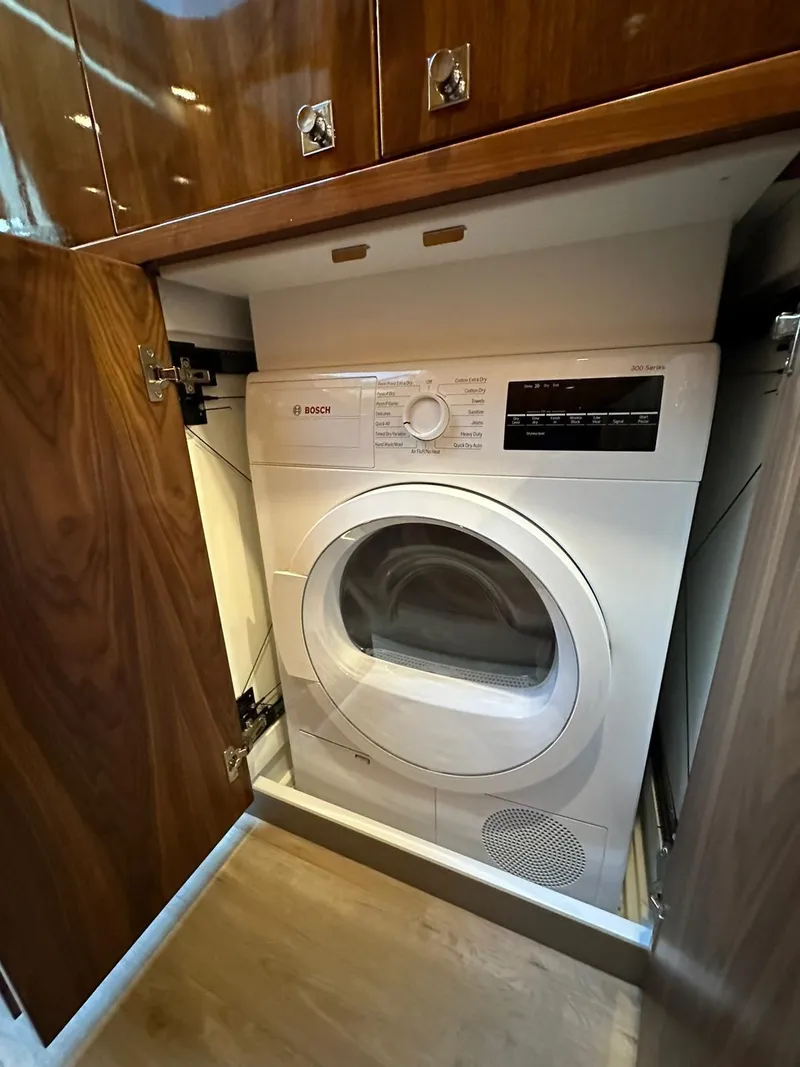 Slide: The Image of Built-in washing machine in Riviera 60SY 2018 yacht's wooden cabinet. - 18