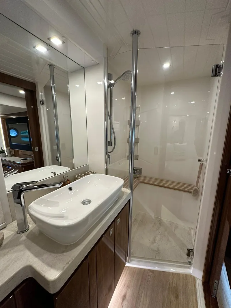 Slide: The Image of Luxurious bathroom in 2018 Riviera 60SY yacht with modern sink and glass shower. - 21