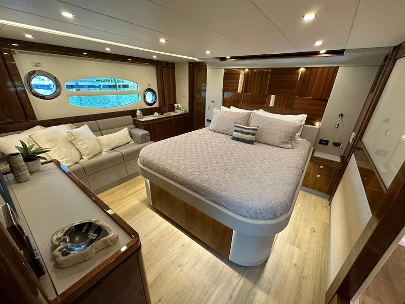 Slide: The Image of Luxurious interior of 2018 Riviera 60SY yacht with elegant bedroom and seating area. - 23