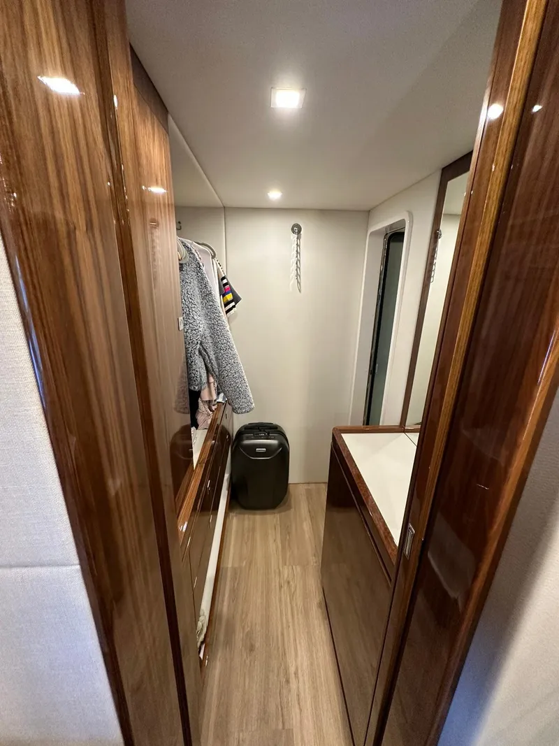 Slide: The Image of Luxurious Riviera 60SY 2018 yacht interior with wooden finishes and modern amenities. - 25