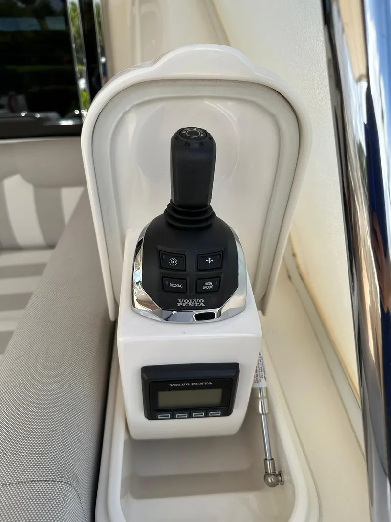 Slide: The Image of Control panel of a 2018 Riviera 60SY yacht, featuring joystick and display. - 27