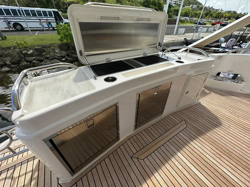 Slide: The Image of Outdoor kitchen on 2018 Riviera 60SY yacht with grill and storage. - 3