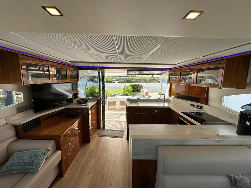 Slide: The Image of Luxurious interior of 2018 Riviera 60SY yacht with modern kitchen and entertainment area. - 9