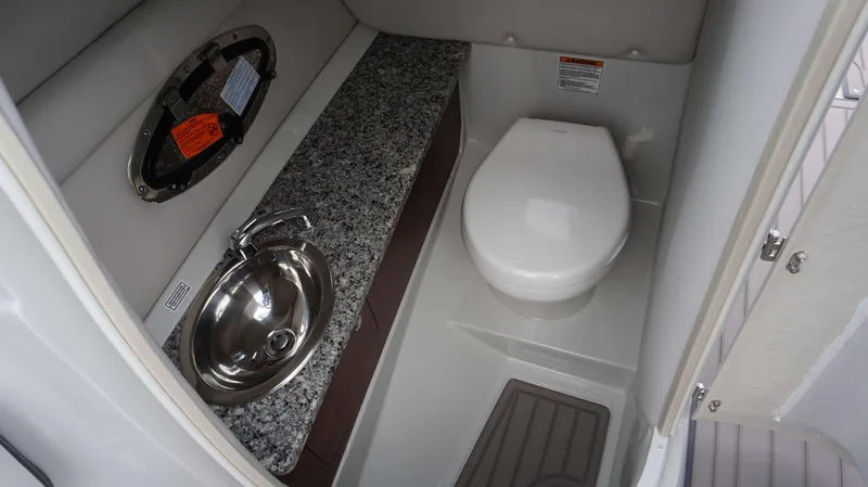 Slide: The Image of 2024 Crownline 260 XS boat bathroom with granite countertop and stainless steel sink. - 15