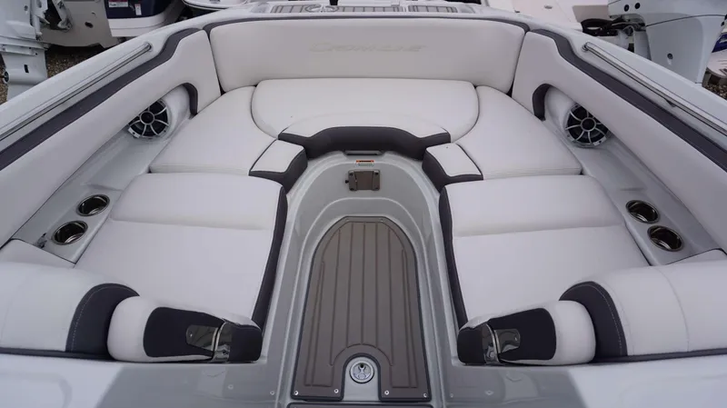 Slide: The Image of 2024 Crownline 260 XS boat interior with white cushioned seating and cup holders. - 25