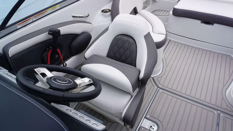 Slide: The Image of 2024 Crownline 260 XS boat interior, featuring a modern steering wheel and comfortable seating. - 4