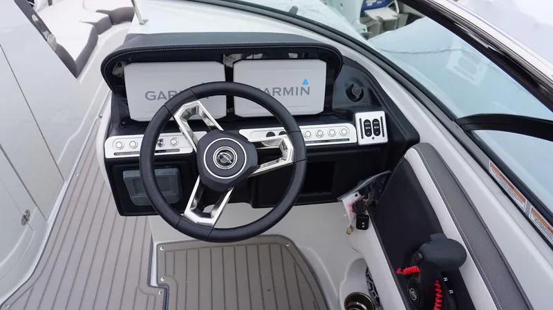 Slide: The Image of 2024 Crownline 260 XS boat dashboard with Garmin navigation system and steering wheel. - 7