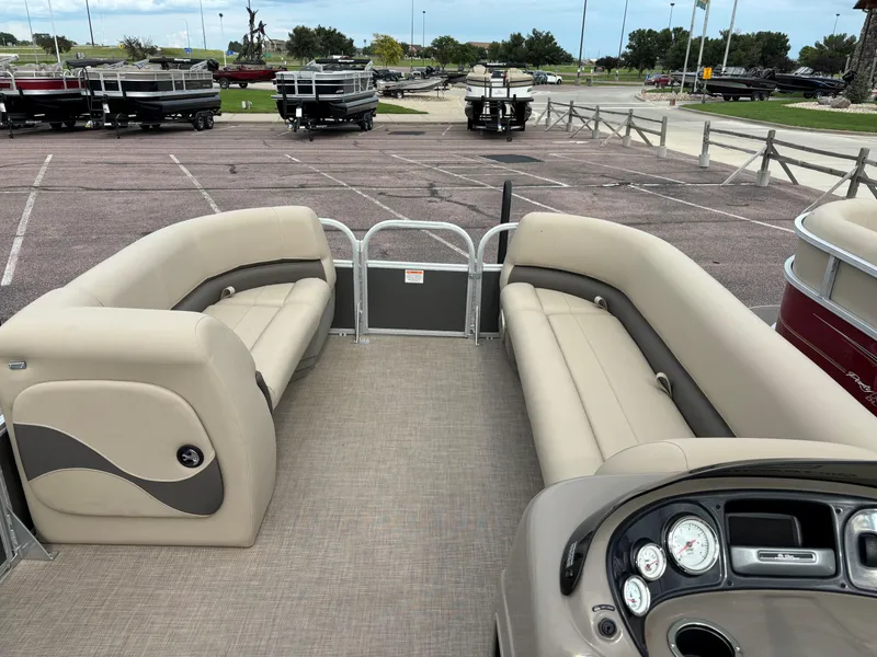 Slide: The Image of 2023 Sun Tracker Party Barge 18 DLX interior with beige seating and control panel. - 4