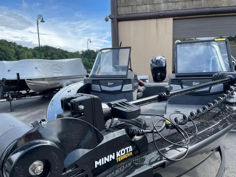 Slide: The Image of 2023 Ranger VX1788 WT boat with Minn Kota Terrova motor in a marina. - 2