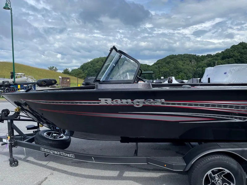Slide: The Image of 2023 Ranger VX1788 WT boat on trailer, black with red accents, parked outdoors. - 3