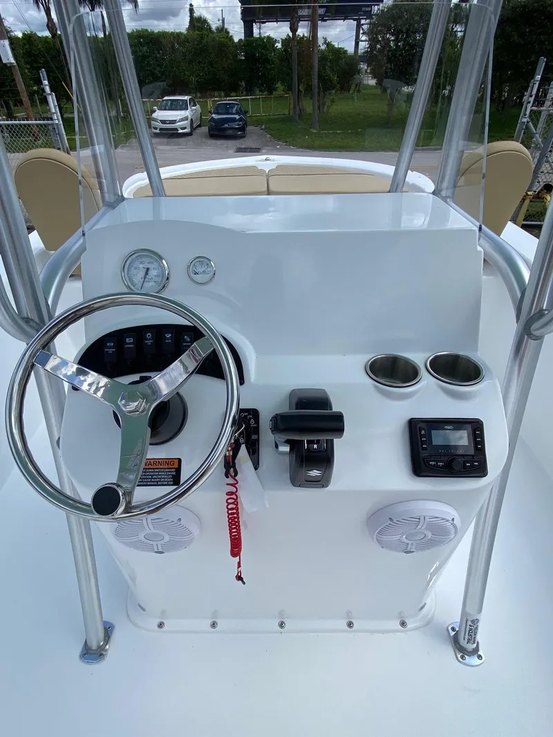 Slide: The Image of 2023 Savannah SS21 boat console with steering wheel, gauges, cup holders, and electronic controls. - 10