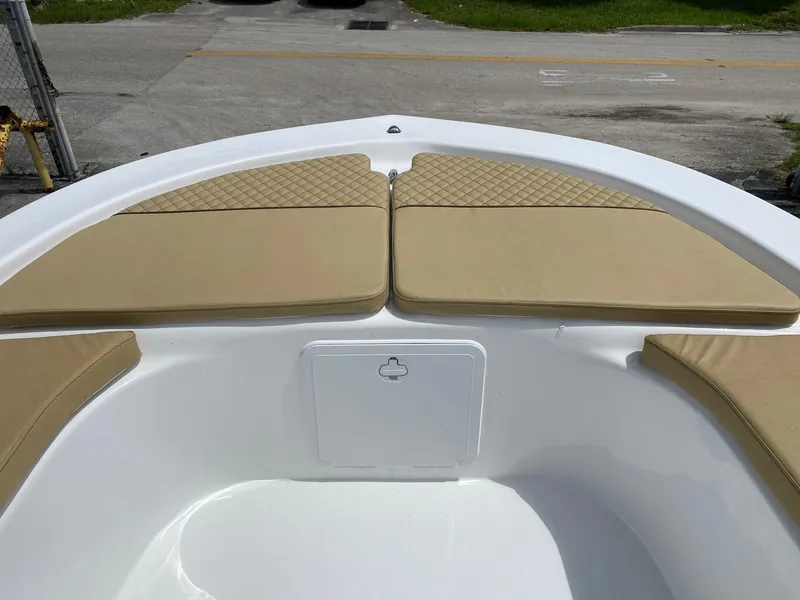 Slide: The Image of Savannah SS21 2023 boat bow with tan cushions and storage compartment. - 16