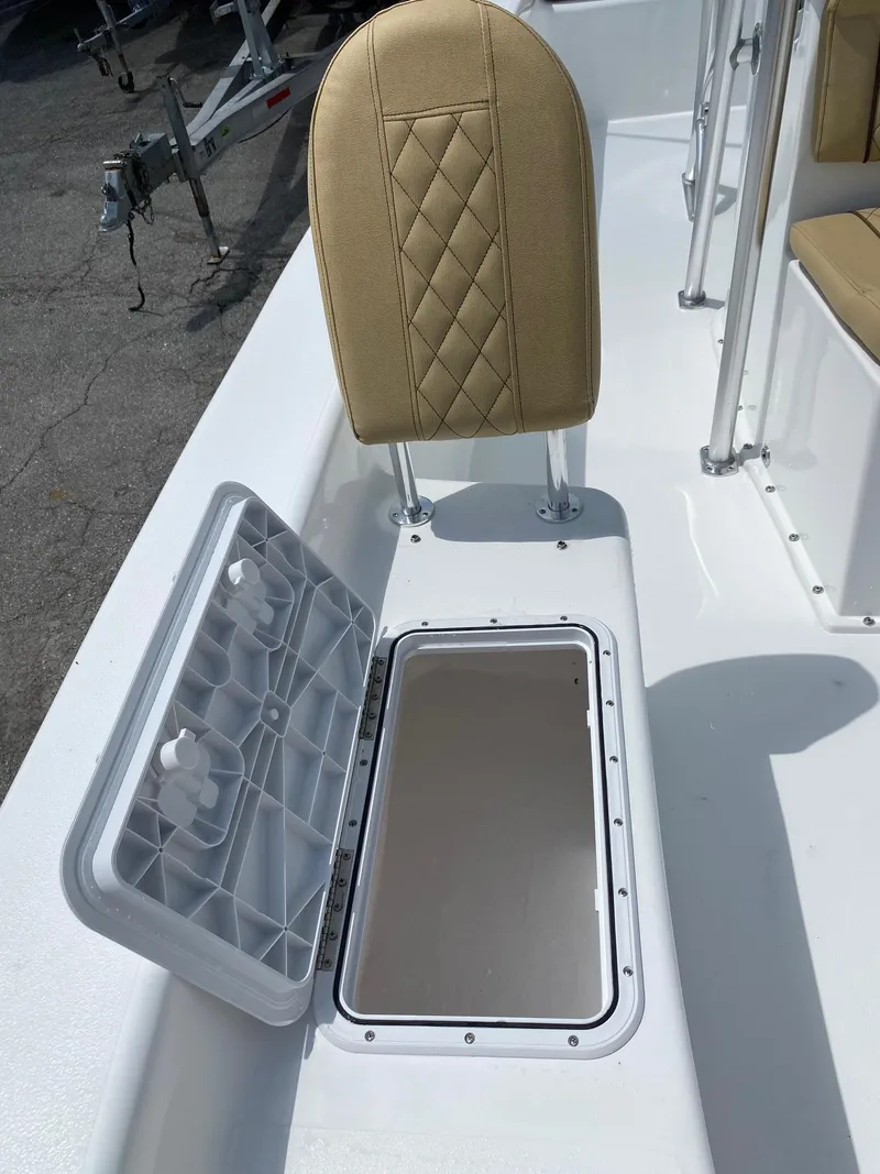 Slide: The Image of 2023 Savannah SS21 boat with open storage compartment and beige cushioned seat. - 20