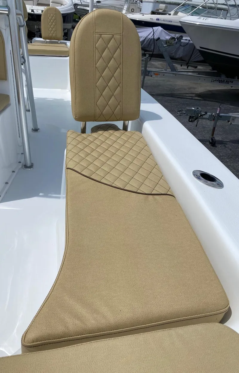 Slide: The Image of 2023 Savannah SS21 boat with tan cushioned seating and diamond stitching. - 21