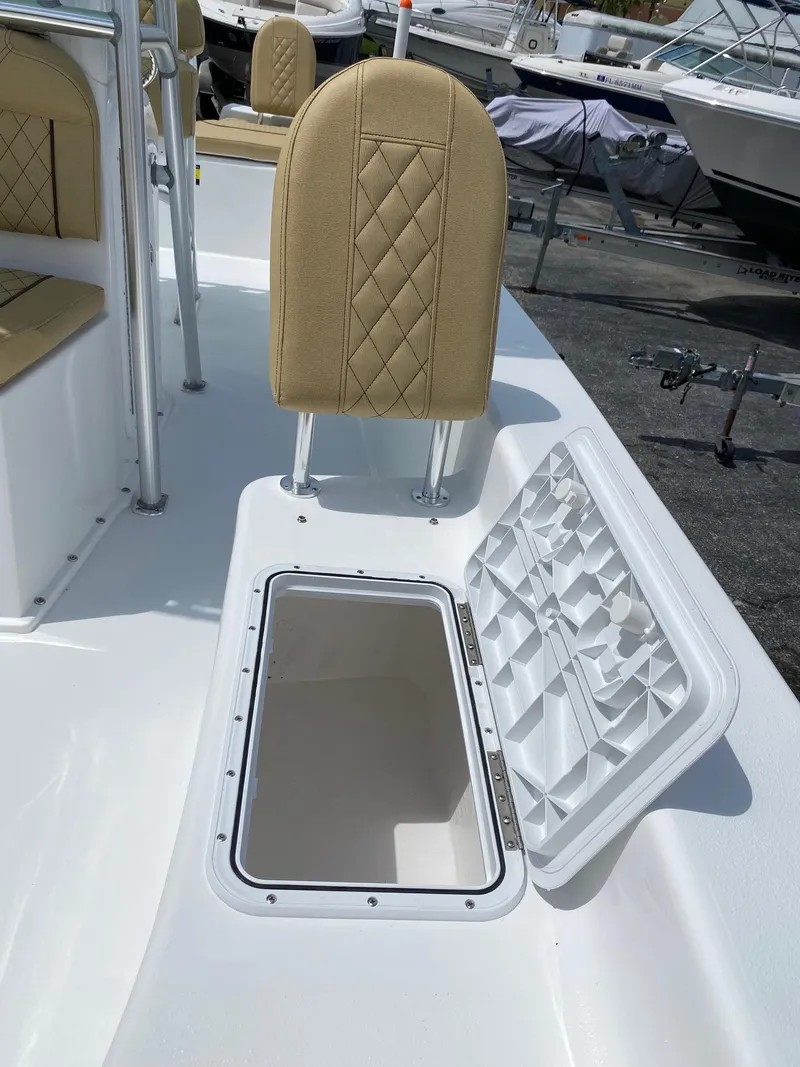 Slide: The Image of 2023 Savannah SS21 boat with open storage compartment and beige seating. - 22