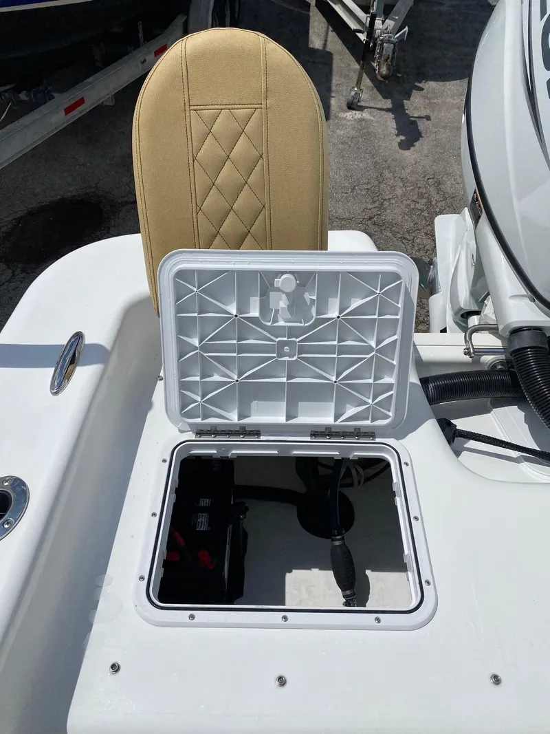 Slide: The Image of 2023 Savannah SS21 boat with open storage compartment and beige seat. - 24