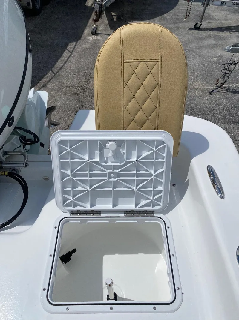 Slide: The Image of Open storage compartment on a 2023 Savannah SS21 boat with beige cushioned seat. - 26