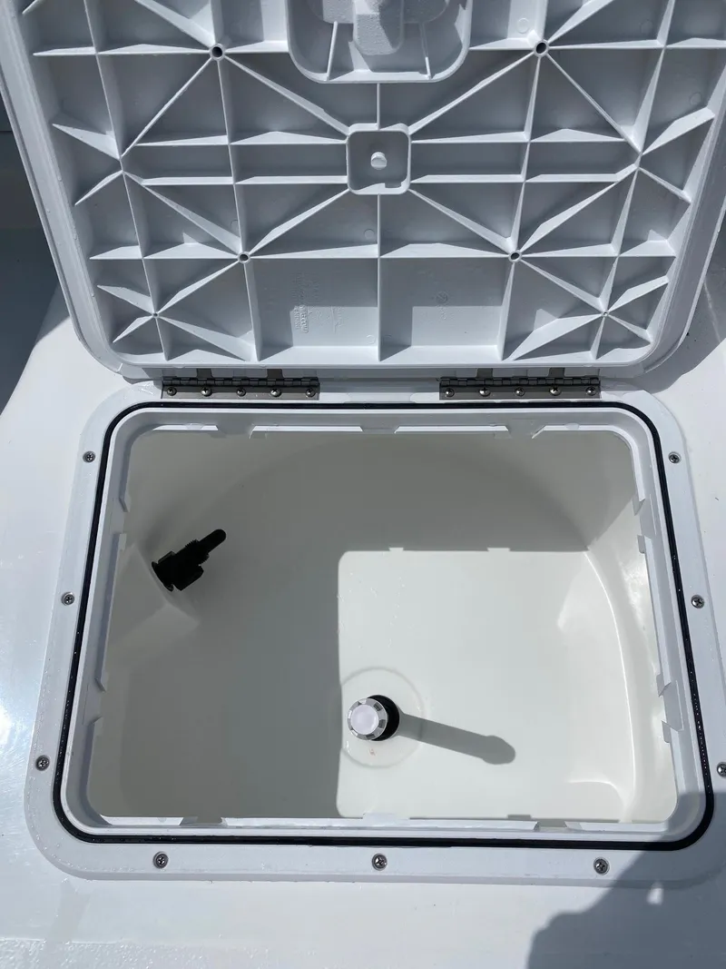 Slide: The Image of Open storage compartment of a 2023 Savannah SS21 boat. - 27