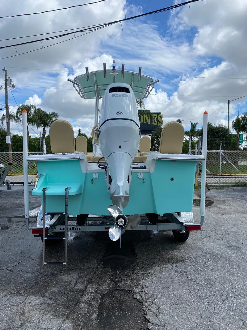 Slide: The Image of 2023 Savannah SS21 boat with outboard motor, teal hull, and beige seats. - 3