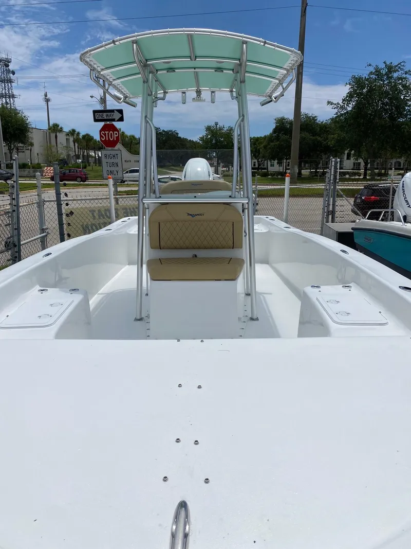 Slide: The Image of 2023 Savannah SS21 boat with T-top and seating, docked outdoors. - 33