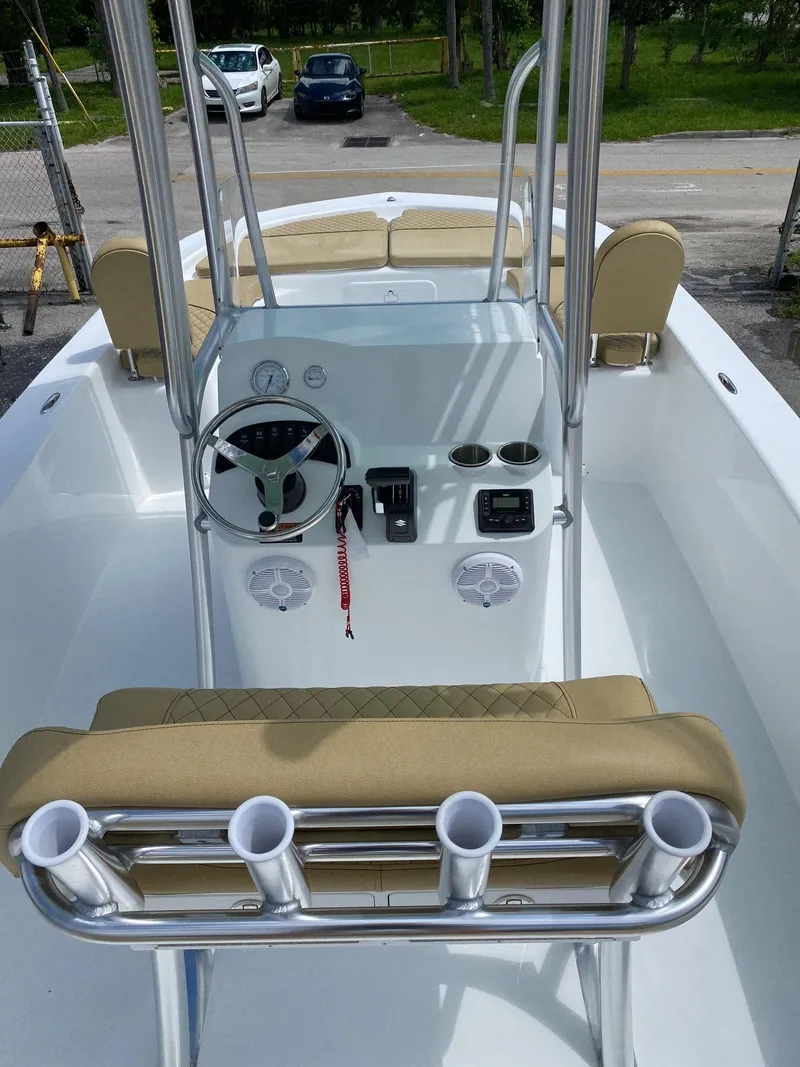 Slide: The Image of 2023 Savannah SS21 boat interior with steering console and rod holders. - 5