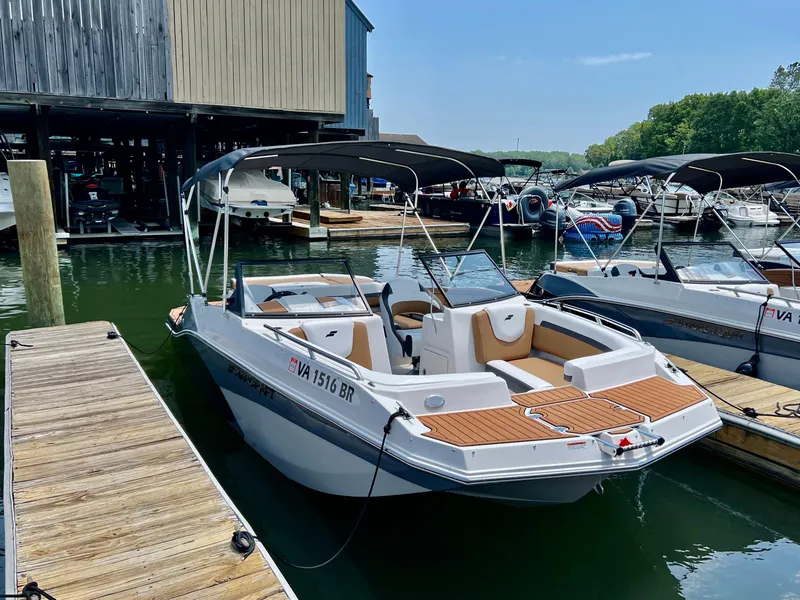 The Image of 2023 Starcraft SVX 210 IO boat docked at a marina. - 1