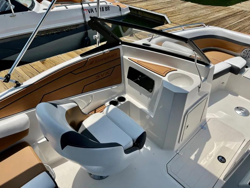 Slide: The Image of 2023 Starcraft SVX 210 IO boat interior with helm seat and dashboard. - 7