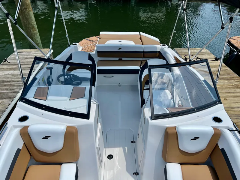 Slide: The Image of 2023 Starcraft SVX 210 IO boat interior with tan and white seating. - 8
