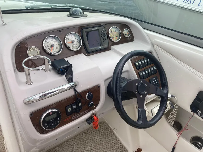 Slide: The Image of 2006 Chaparral 276 SSi boat dashboard with steering wheel, gauges, and navigation system. - 11
