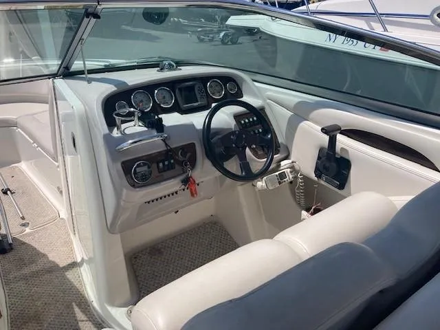 Slide: The Image of 2006 Chaparral 276 SSi boat cockpit with steering wheel and control panel. - 5