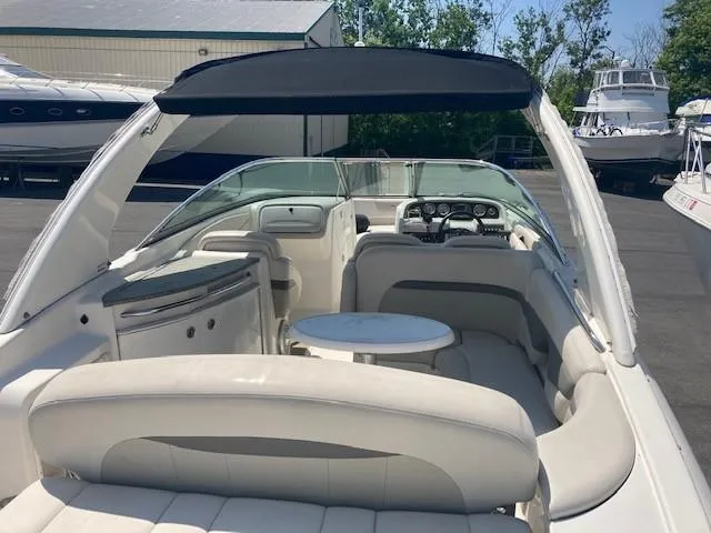 Slide: The Image of 2006 Chaparral 276 SSi boat interior with seating and table, docked at marina. - 7