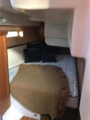Slide: The Image of 2018 Catalina 425 yacht cabin with cozy bed, pillows, and brown blanket. - 19