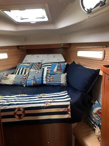 Slide: The Image of 2018 Catalina 425 cabin interior with nautical-themed bedding and wooden accents. - 20
