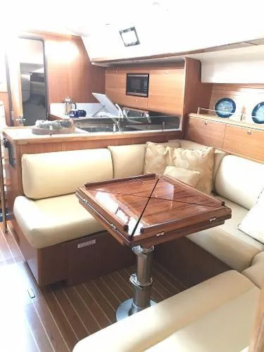 Slide: The Image of Interior of 2018 Catalina 425 yacht with elegant seating and wooden table. - 23