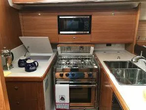 Slide: The Image of Modern kitchen in 2018 Catalina 425 yacht with stove, microwave, and dual sink. - 25