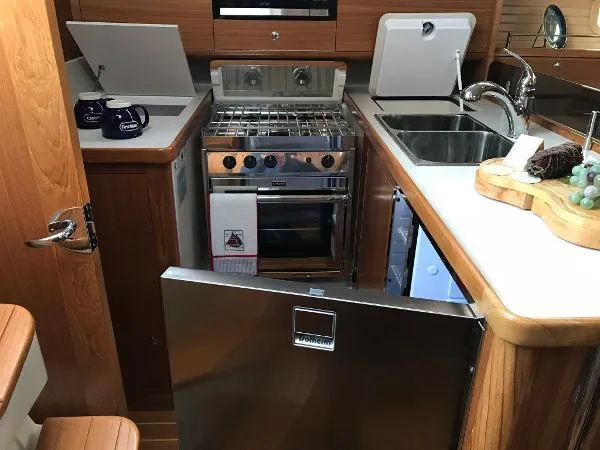 Slide: The Image of Compact kitchen in 2018 Catalina 425 yacht with stove, sink, and fridge. - 27
