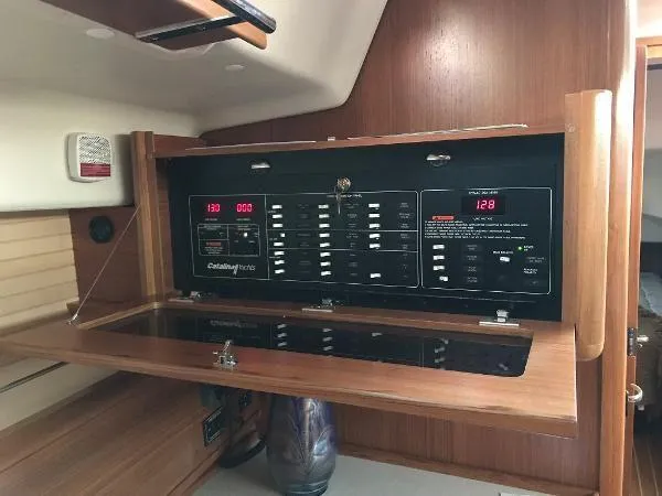 Slide: The Image of Electrical panel inside a 2018 Catalina 425 yacht, featuring control switches and displays. - 30