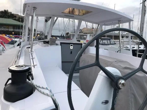 Slide: The Image of 2018 Catalina 425 sailboat cockpit with steering wheel and winch, docked at marina. - 7