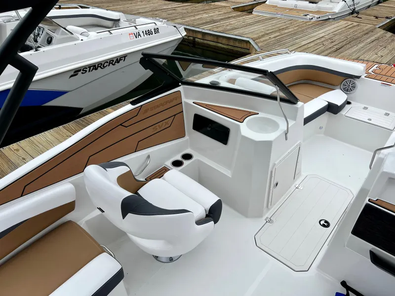 Slide: The Image of 2023 Starcraft SVX 210 IO Wake Tower boat interior with seating and dashboard. - 4