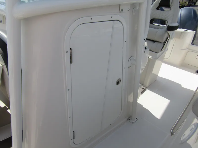 Slide: The Image of 2024 Sailfish 242 CC boat interior with storage compartment door. - 14