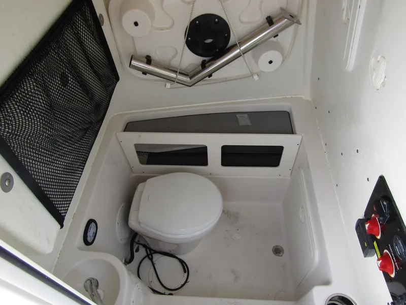 Slide: The Image of 2024 Sailfish 242 CC boat interior with marine toilet and storage. - 15