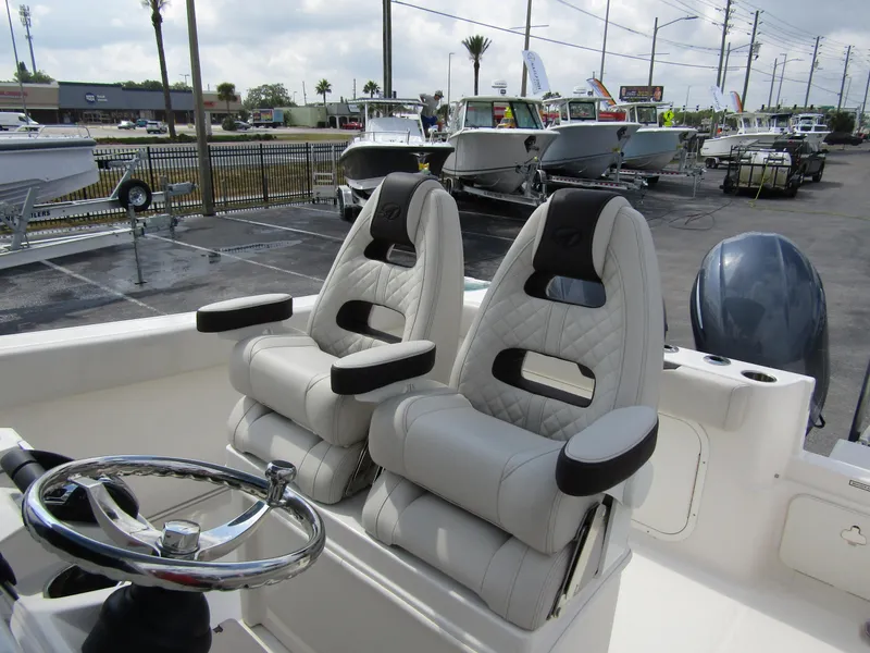 Slide: The Image of 2024 Sailfish 242 CC boat with dual captain's chairs and steering wheel. - 17