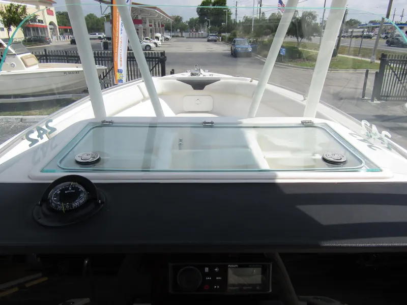 Slide: The Image of 2024 Sailfish 242 CC center console boat interior view with compass and windshield. - 20