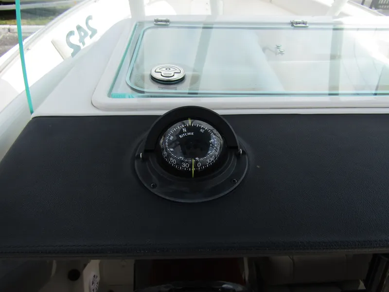 Slide: The Image of Compass on the dashboard of a 2024 Sailfish 242 CC boat. - 21